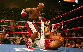 LAS VEGAS - MAY 14:  Zab 'Super' Judah (L) knocks down Cosme Rivera for the second time in the first round during the welterweight championship bout at the MGM Grand Garden Arena on May 14, 2005 in Las Vegas, Nevada.  Judah retained the belt after a third