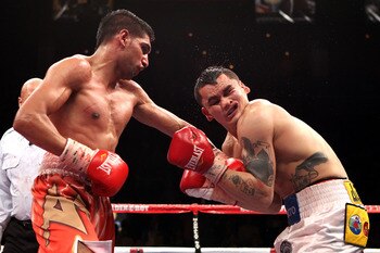 LAS VEGAS - DECEMBER 11:  (L-R) Amir Khan of England connects with a left to the face of Marcos Maidana of Argentina during the WBA super lightweight title fight at Mandalay Bay Events Center on December 11, 2010 in Las Vegas, Nevada.  (Photo by Scott Hea