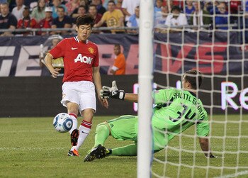 FOXBORO, MA - JULY 13:  Ji-Sung Park #13 of the Manchester United scores a goal against Bobby Shuttleworth #34 of the New England Revolution during a friendly match at Gillette Stadium on July 13, 2011 in Foxboro, Massachusetts. (Photo by Jim Rogash/Getty