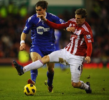 STOKE ON TRENT, ENGLAND - JANUARY 15:  Johan Elmander of Bolton Wanderers is challenged by Robert Huth of Stoke City during the Barclays Premier League match between Stoke City and Bolton Wanderers at Britannia Stadium on January 15, 2011 in Stoke on Tren