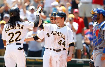PITTSBURGH - JULY 10:  Andrew McCutchen #22 of the Pittsburgh Pirates is congratulated by teammates Alex Presley #44 and Neil Walker #18 after hitting a three run home run against the Chicago Cubs in the third inning during the game on July 10, 2011 at PN