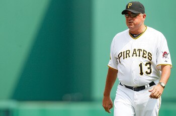PITTSBURGH - JUNE 12:  Manager Clint Hurdle #13 of the Pittsburgh Pirates walks back to the dugout after being thrown out of the game against the New York Mets during the game on June 12, 2011 at PNC Park in Pittsburgh, Pennsylvania.  (Photo by Jared Wick