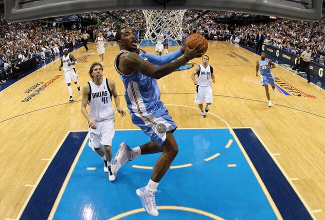 DALLAS - MAY 11:  Guard J.R. Smith #1 of the Denver Nuggets takes a shot against Dirk Nowitzki #41 of the Dallas Mavericks in Game Four of the Western Conference Semifinals during the 2009 NBA Playoffs at American Airlines Center on May 11, 2009 in Dallas
