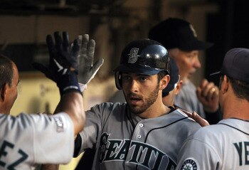 OAKLAND, CA - JULY 05:  Dustin Ackley #13 of the Seattle Mariners is congratulated by teammates in the dugout after he hit a home run in the seventh inning against the Oakland Athletics at Oakland-Alameda County Coliseum on July 5, 2011 in Oakland, Califo