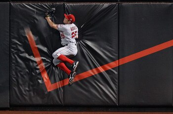 NEW YORK - JUNE 17:  Peter Bourjos #25 of the Los Angeles Angels of Anaheim crashes into the wall after catching Ronny Paulino's #9 (not pictured) of the New York Mets fly ball on June 17, 2011 at Citi Field in the Flushing neighborhood of the Queens boro