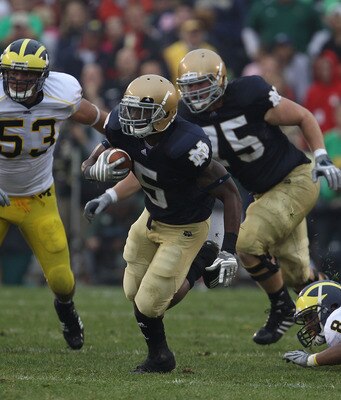 SOUTH BEND, IN - SEPTEMBER 11: Armando Allen, Jr. #5 of the Notre Dame Fighting Irish runs against the Michigan Wolverines closes in at Notre Dame Stadium on September 11, 2010 in South Bend, Indiana. Michigan defeated Notre Dame 28-24.  (Photo by Jonatha