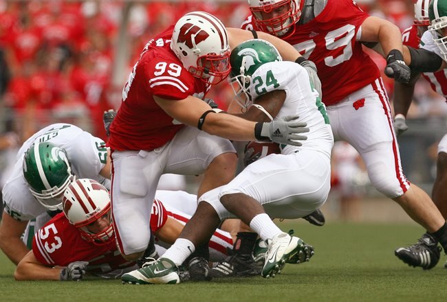 MADISON, WI - SEPTEMBER 26: J.J. Watt #99 of the Wisconsin Badgers tackles Caulton Ray #24 of the Michigan State Spartans on September 26, 2009 at Camp Randall Stadium in Madison, Wisconsin. Wisconsin defeated Michigan State 38-30. (Photo by Jonathan Dani