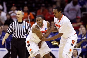 CLEVELAND, OH - MARCH 18:  Kris Joseph #32 of the Syracuse Orange helps up Scoop Jardine #11 after he Indiana State Sycamores injured during the second half against the Indiana State Sycamores during the second round of the 2011 NCAA men's basketball tour