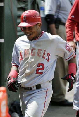OAKLAND, CA - JULY 16: Erick Aybar #2 of the Los Angeles Angels of Anaheim returns to the dugout and celebrates after he hit a home run against the Oakland Athletics in the seventh inning during an MLB baseball game at the O.co Coliseum July 16, 2011 in O
