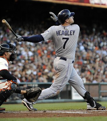 SAN FRANCISCO, CA - JULY 6: Chase Headley #7 of the San Diego Padres hits a sacrifice fly to right field, driving in teammate Chirs Denorfia #13 from third base against the San Francisco Giants in the third inning during a MLB baseball game at AT&T Park J