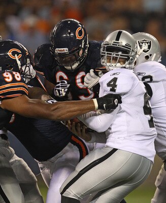 CHICAGO - AUGUST 21: Colt Brennan #4 of the Oakland Raiders tries to escape from Corey Wootton #98 of the Chicago Bears during a preseason game at Soldier Field on August 21, 2010 in Chicago, Illinois. The Raiders defeated the Bears 32-17. (Photo by Jonat
