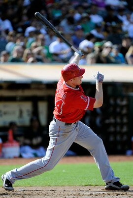 OAKLAND, CA - JULY 16: Mark Trumbo #44 of the Los Angeles Angels of Anaheim swings and watches the flight of his ball as he hits a two-run home run against the Oakland Athletics in the second inning of game two of a double header at the O.co Coliseum July