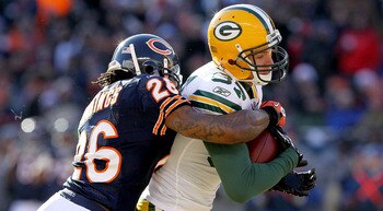 CHICAGO, IL - JANUARY 23:  Wide receiver Jordy Nelson #87 of the Green Bay Packers catches a 22-yard pass as he is tackled by Tim Jennings #26 of the Chicago Bears in the first quarter of the NFC Championship Game at Soldier Field on January 23, 2011 in C
