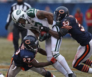 CHICAGO, IL - DECEMBER 26: Braylon Edwards #17 of the New York Jets is tackled by Major Wright #27 and Charles Tillman #33 of the Chicago Bears at Soldier Field on December 26, 2010 in Chicago, Illinois. The Bears defeated the Jets 38-34. (Photo by Jonath