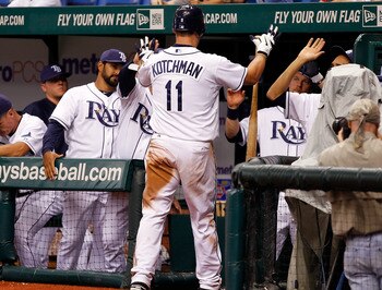 ST. PETERSBURG, FL - JULY 16:  Infielder Casey Kotchman #11 of the Tampa Bay Rays celebrates after scoring a run against the Boston Red Sox during the game at Tropicana Field on July 16, 2011 in St. Petersburg, Florida.  (Photo by J. Meric/Getty Images)