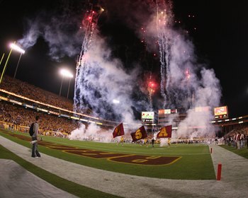 TEMPE, AZ - NOVEMBER 7:  The Arizona State Sun Devils run out onto the field as fireworks light the night sky before the college football game against the USC Trojans on November 7, 2009 at Sun Devil Stadium in Tempe, Arizona.  USC won 14-9.  (Photo by Je