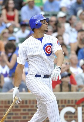 CHICAGO, IL - JUNE 27:  Carlos Pena #22  of the Chicago Cubs watches his two-run homer scoring Aramis Ramirez during the fifth inning against the Colorado Rockies at Wrigley Field on June 27, 2011 in Chicago, Illinois.  (Photo by Brian Kersey/Getty Images