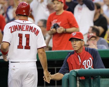 WASHINGTON, DC - JULY 07: Manager Davey Johnson #5 congratulates Ryan Zimmerman #11 of the Washington Nationals after he scored during the third inning against the Chicago Cubs at Nationals Park on July 7, 2011 in Washington, DC.  (Photo by Rob Carr/Getty