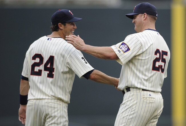 MINNEAPOLIS, MN - JULY 17: Trevor Plouffe #24 and Jim Thome #25 of the Minnesota Twins celebrate a win against the Kansas City Royals on July 17, 2011 at Target Field in Minneapolis, Minnesota. The Twins defeated the Royals 4-3. (Photo by Hannah Foslien/G