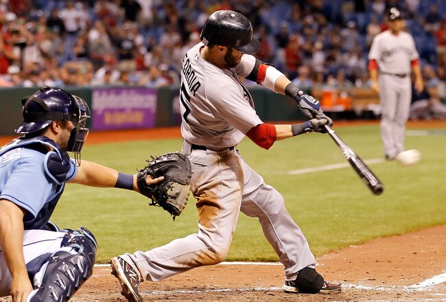 ST. PETERSBURG, FL - JULY 17:  Infielder Dustin Pedroia #15 of the Boston Red Sox singles in the winning run against the Tampa Bay Rays during the game at Tropicana Field on July 17, 2011 in St. Petersburg, Florida.  (Photo by J. Meric/Getty Images)