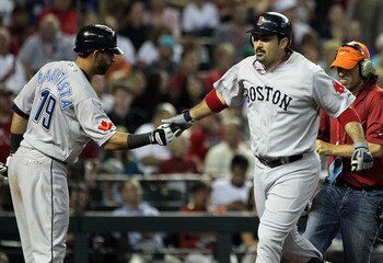 PHOENIX, AZ - JULY 12:  American League All-Star Adrian Gonzalez #28 of the Boston Red Sox is congratulated by American League All-Star Jose Bautista #19 of the Toronto Blue Jays as he runs the bases after hitting a home run in the fourth inning of the 82