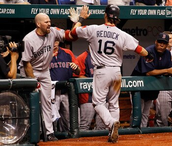 ST. PETERSBURG, FL - JULY 17:  Infielder Kevin Youkilis #20 of the Boston Red Sox congratulates Josh Reddick #16 after scoring the winning run against the Tampa Bay Rays during the game at Tropicana Field on July 17, 2011 in St. Petersburg, Florida.  (Pho