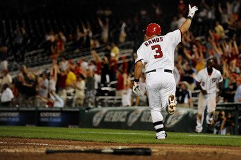 WASHINGTON, DC - JUNE 21: Wilson Ramos #3 of the Washington Nationals celebrates his three run home run in the bottom of the ninth inning to defeat the Seattle Mariners at Nationals Park on June 21, 2011 in Washington, DC. Washington Nationals won, 6-5, o