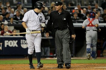 NEW YORK - OCTOBER 19:  Lance Berkman #17 of the New York Yankees talks with home plate umpire Angel Hernandez after striking out against the Texas Rangers in Game Four of the ALCS during the 2010 MLB Playoffs at Yankee Stadium on October 19, 2010 in the