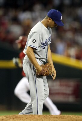 PHOENIX, AZ - JULY 17:  Starting pitcher Ted Lilly #29 of the Los Angeles Dodgers reacts after giving up a solo home run to Ryan Roberts #14 of the Arizona Diamondbacks during the second inning of the Major League Baseball game at Chase Field on July 17,