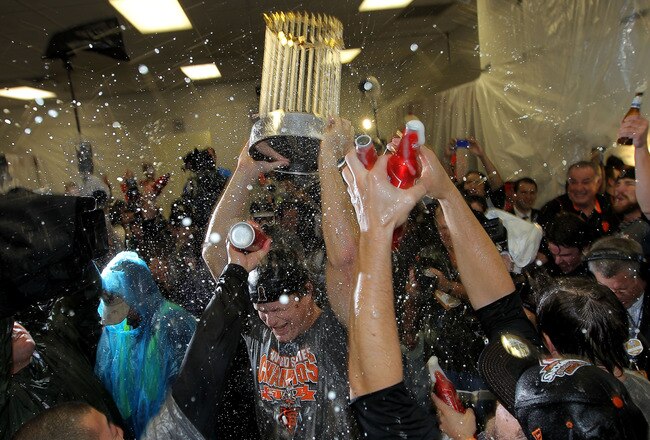 ARLINGTON, TX - NOVEMBER 01:  Matt Cain of the San Francisco Giants holds up the World Series trophy as he celebrates with his teammates in the locker room after the Giants won 3-1 against the Texas Rangers in Game Five of the 2010 MLB World Series at Ran
