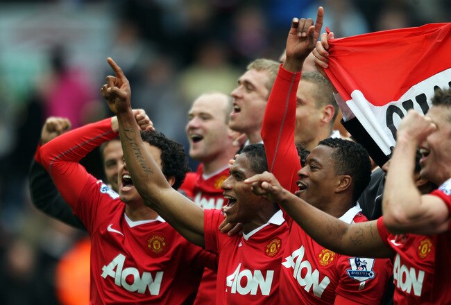 BLACKBURN, ENGLAND - MAY 14:  Fabio, Antonio Valencia and Patrice Evra of Manchester United celebrate after drawing the Barclays Premier League match between Blackburn Rovers and Manchester United but winning the title at Ewood park on May 14, 2011 in Bla