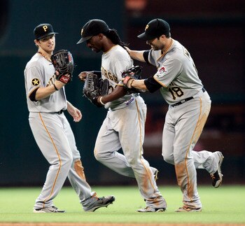 HOUSTON - JULY 17: Center fielder Andrew McCutchen #22 of the Pittsburgh Pirates is congratulated by Neil Walker #18 and Alex Pressley #44 after makeing a sliding catch on a fly ball off the bat of Clint Barmes #12 of the Houston Astros in the eighth inni