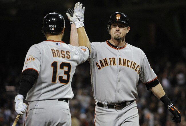 SAN DIEGO, CA - JULY 14: Aubrey Huff #17 of the San Francisco Giants is congratulated by teammate Cody Ross #13 after Huff hit a solo home run during the ninth inning of a baseball game against the San Diego Padres at Petco Park on July 14, 2011 in San Di
