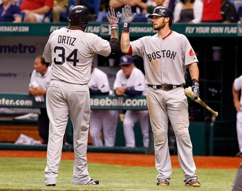 ST PETERSBURG, FL - JULY 16:  Designated hitter David Ortiz #34 of the Boston Red Sox is congratulated by catcher Jarrod Saltalamacchia #39 after scoring a run against the Tampa Bay Rays during the game at Tropicana Field on July 16, 2011 in St. Petersbur