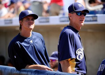 PHOENIX, AZ - MARCH 10:  Pitcher Zack Greinke #13  of the Milwaukee Brewrers stands near manager Ron Roenicke during the spring training baseball game against Colorado Rockies at Maryvale Baseball Park on March 10, 2011 in Phoenix, Arizona.  (Photo by Kev