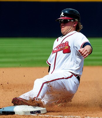 ATLANTA - JULY 7: Nate McLouth #13 of the Atlanta Braves steals third base against the Colorado Rockies at Turner Field on July 7, 2011 in Atlanta, Georgia. (Photo by Scott Cunningham/Getty Images)