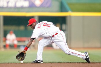 CINCINNATI, OH - JULY 16: Edgar Renteria #16 of the Cincinnati Reds fields a ground ball during the game against the St. Louis Cardinals at Great American Ball Park on July 16, 2011 in Cincinnati, Ohio. The Cardinals won 4-1. (Photo by Joe Robbins/Getty I