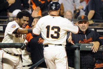 SAN FRANCISCO, CA - JULY 18: Cody Ross #13 of the San Francisco Giants celebrates with Pablo Sandoval #48 and manager Bruce Bochy #15 after he scored on an RBI single by Brandon Crawford against the Los Angeles Dodgers in the sixth inning during an MLB ba
