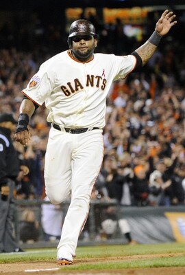 SAN FRANCISCO, CA - JULY 18:  Pablo Sandoval #48 of the San Francisco Giants scores and waves home Nate Schierholtz on a two-RBI double by Cody Ross against the Los Angeles Dodgers in the sixth inning during an MLB baseball game at AT&T Park July 18, 2011