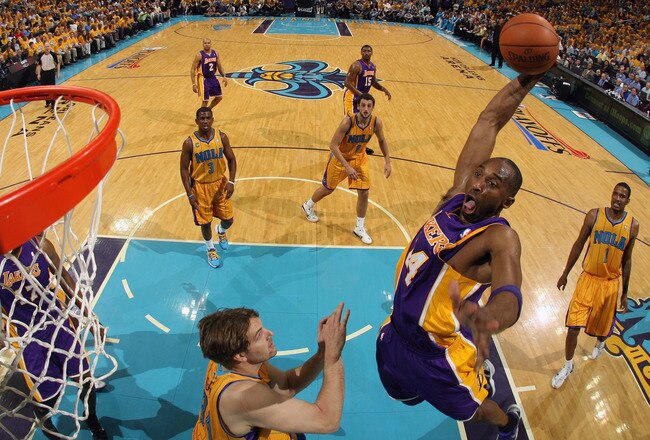 NEW ORLEANS, LA - APRIL 22:  Kobe Bryant #24 of the Los Angeles Lakers dunks the ball over Aaron Gray #24 of the New Orleans Hornets in Game Three of the Western Conference Quarterfinals in the 2011 NBA Playoffs at the New Orleans Arena  on April 22, 2011