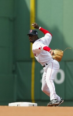 BOSTON - APRIL 17:  Shortstop Pokey Reese #3 of the Boston Red Sox throws the ball to first base during the game against the New York Yankees on April 17, 2004 at Fenway Park in Boston, Massachusetts. The Red Sox won 5-2.  (Photo by Ezra Shaw/Getty Images