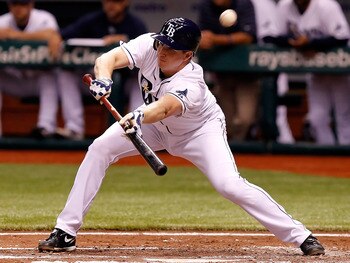 ST. PETERSBURG, FL - JULY 18:  Infielder Elliot Johnson #9 of the Tampa Bay Rays attempts a bunt against the New York Yankees during the game at Tropicana Field on July 18, 2011 in St. Petersburg, Florida.  (Photo by J. Meric/Getty Images)