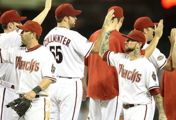 PHOENIX, AZ - JULY 18:  Ryan Roberts #14 of the Arizona Diamondbacks high fives teammate Josh Collmenter #55 after defeating the Milwaukee Brewers in the Major League Baseball game at Chase Field on July 18, 2011 in Phoenix, Arizona. The Diamondbacks defe