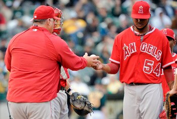 OAKLAND, CA - JULY 16: Manager Mike Scioscia #14 of the Los Angeles Angels of Anaheim takes the ball from pitcher Ervin Santana #54 against the Oakland Athletics in the seventh inning of game two of a double header at the O.co Coliseum July 16, 2011 in Oa