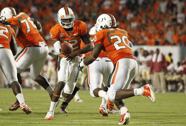 MIAMI, FL - OCTOBER 9: Jacory Harris #12 hands the ball off to Damien Berry #20 of the Miami Hurricanes against the Florida State Seminoles on October 9, 2010 at Sun Life Stadium in Miami, Florida. The Seminoles defeated the Hurricanes 45-17. (Photo by Jo