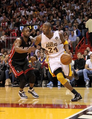 MIAMI, FL - MARCH 10:  Kobe Bryant #24 of the Los Angeles Lakers drives past Dwyane Wade #3 of the Miami Heat during a game at American Airlines Arena on March 10, 2011 in Miami, Florida. NOTE TO USER: User expressly acknowledges and agrees that, by downl