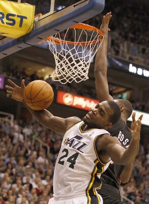 SALT LAKE CITY, UT - DECEMBER 8:  Paul Millsap #24 of the Utah Jazz is fouled by Chris Bosh #1 of the Miami Heat during the second half of an NBA game December 8, 2010 at Energy Solutions Arena in Salt Lake City, Utah. The Heat beat the Jazz 111-98. NOTE