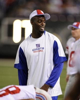 EAST RUTHERFORD, NJ - AUGUST 23:  Plaxico Burress #17 of the New York Giants watches from the sidelines during a preseason NFL game against the New York Jets at Giants Stadium in the Meadowlands on August 23, 2008 in East Rutherford, New Jersey.  (Photo b