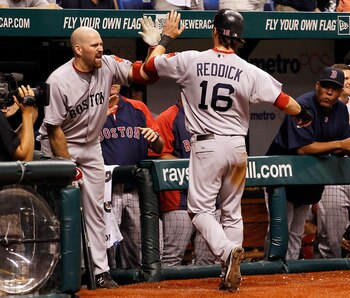 ST. PETERSBURG, FL - JULY 17:  Infielder Kevin Youkilis #20 of the Boston Red Sox congratulates Josh Reddick #16 after scoring the winning run against the Tampa Bay Rays during the game at Tropicana Field on July 17, 2011 in St. Petersburg, Florida.  (Pho