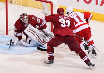 GLENDALE, AZ - APRIL 20:  Goaltender Ilya Bryzgalov #30 of the Phoenix Coyotes makes a pad save on the shot as Daniel Cleary #11 of the Detroit Red Wings skates in in Game Four of the Western Conference Quarterfinals during the 2011 NHL Stanley Cup Playof